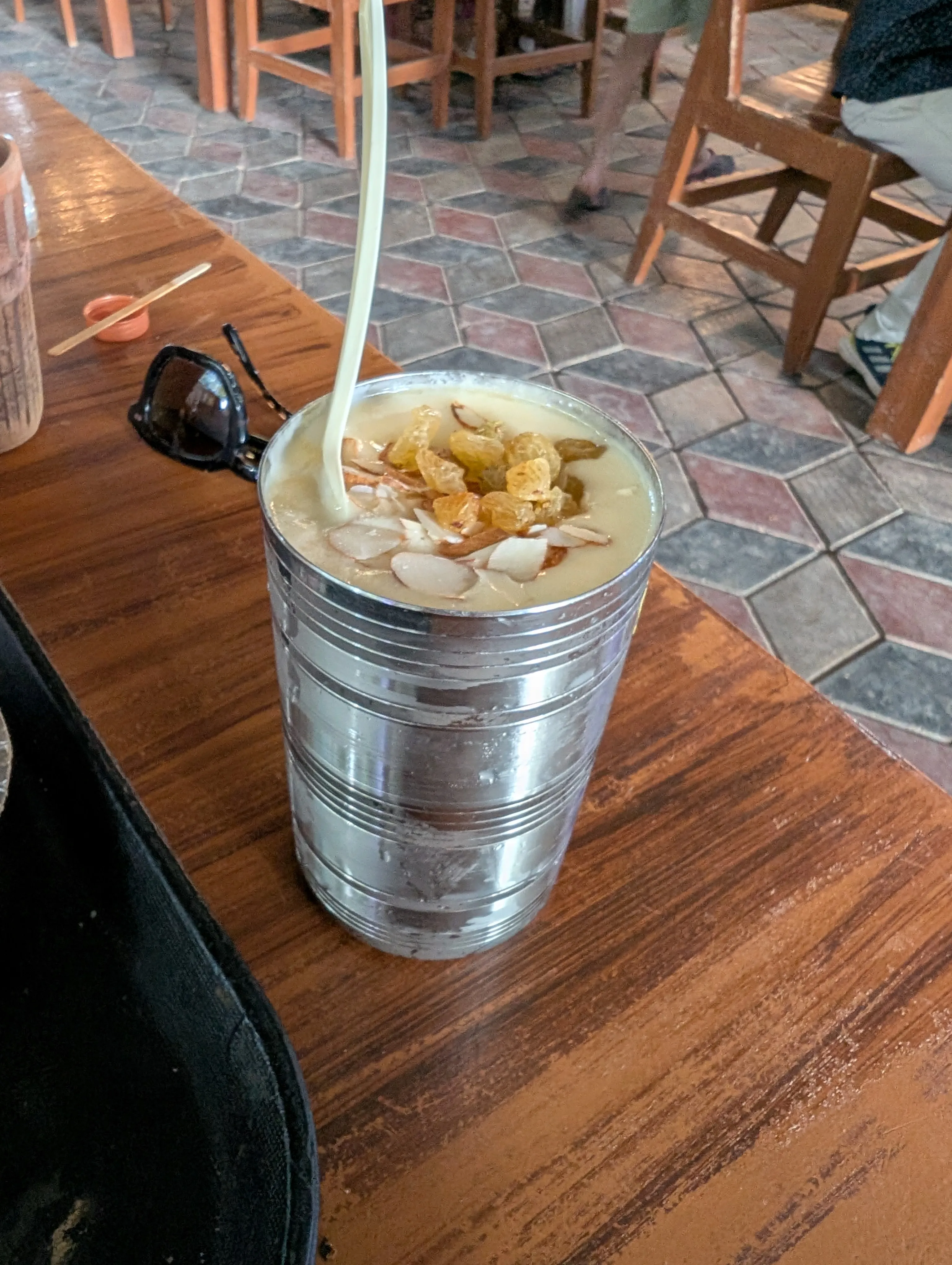 The best mango lassi I have ever had — thick, cold, topped with almonds and raisins, in Sawai Madhopur.