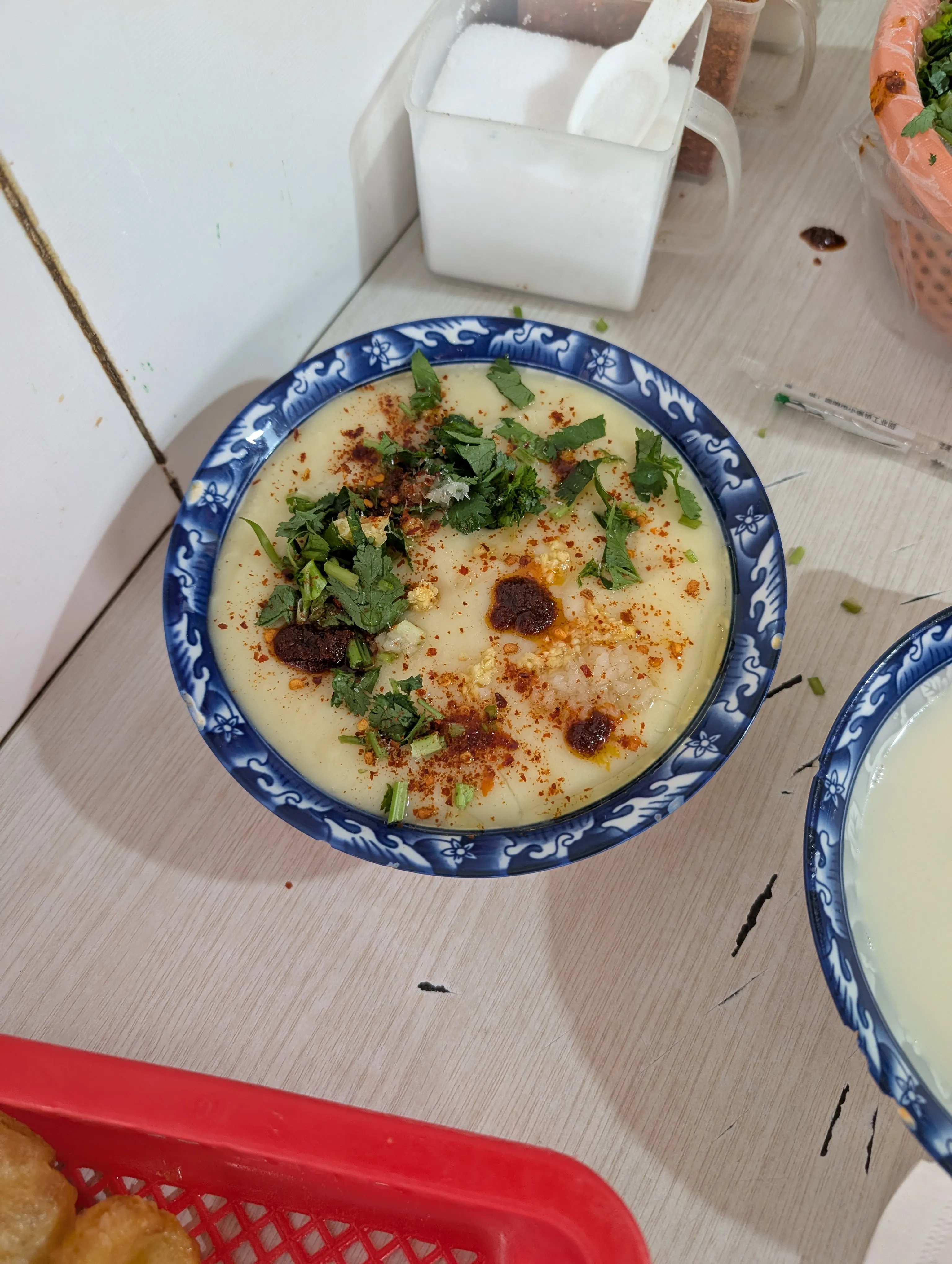 A warming porridge made with spiced soy broth, served alongside fried dough sticks.